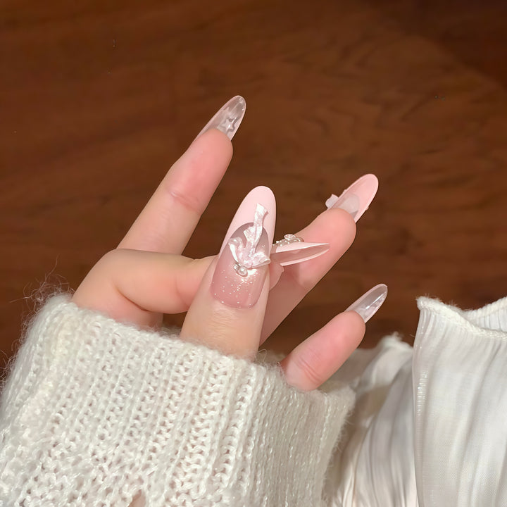 Artificial nail tips with glamorous glitter and bow details Kalsten