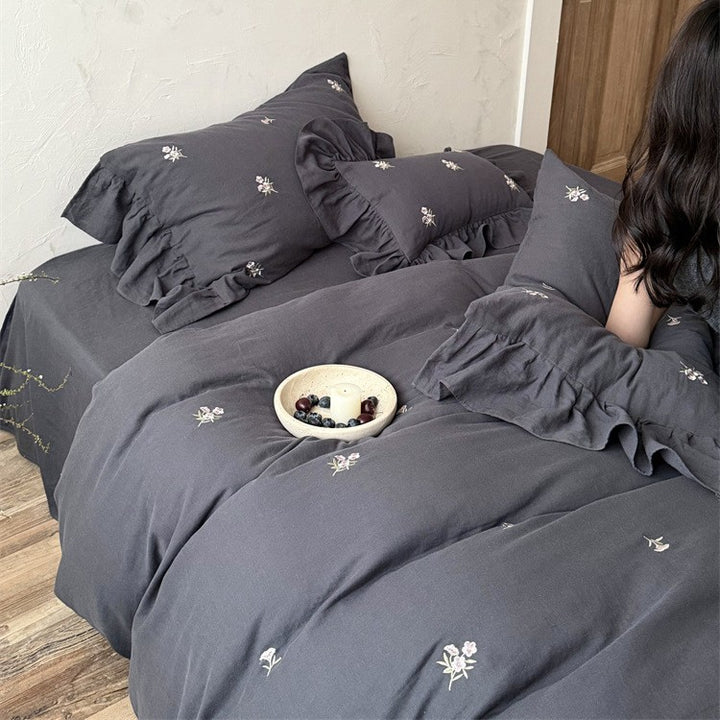 Cotton satin bedding set with delicate embroidered flowers, ruffled decorative pillow, and hotel closure Kalsten
