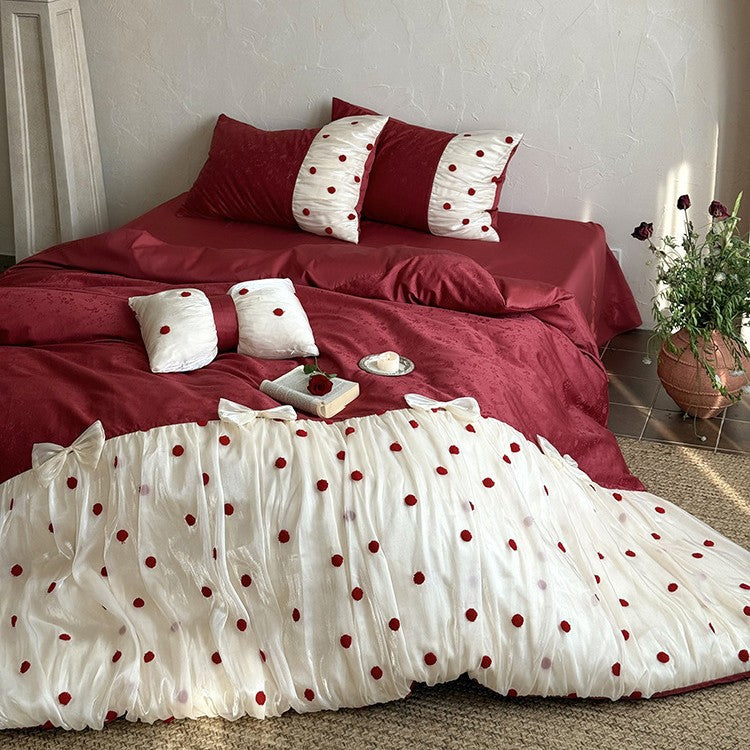 Romantic bed linen set with tulle overlay, pom pom appliqués, and decorative bows