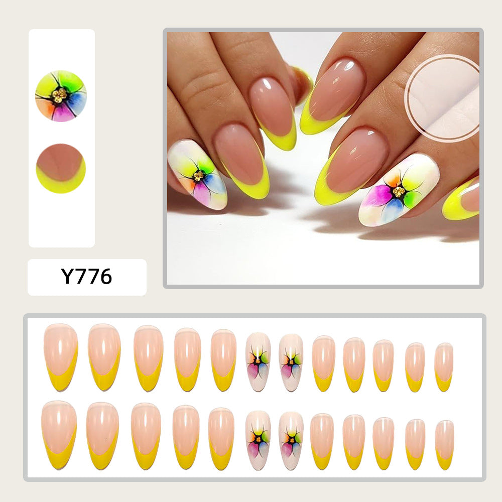 Stylish artificial nails with floral accents and colorful French tip design Kalsten