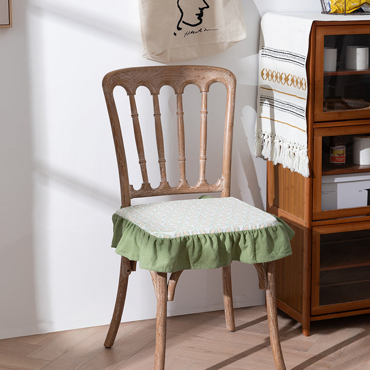 Padded chair cushion with ties, ruffled edge and embroidered hole pattern look Kalsten