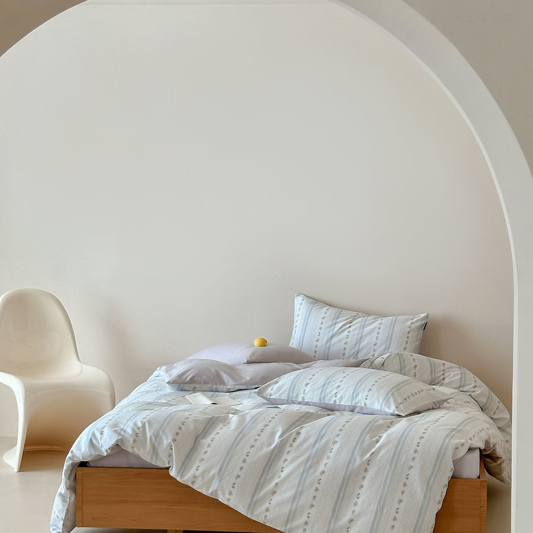 Cotton percale bed linen set with subtle floral stripe pattern and reversible material