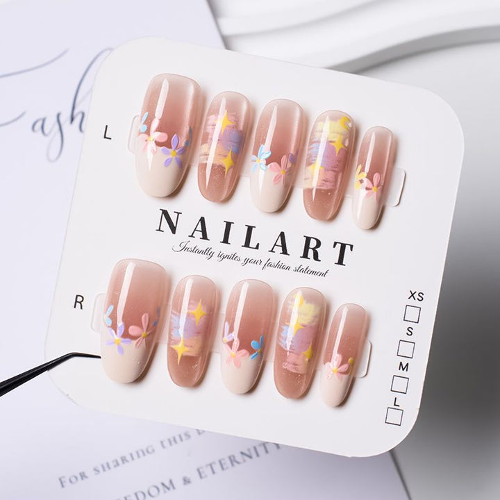 Artificial nails with delicate floral accents and glitter effects Kalsten
