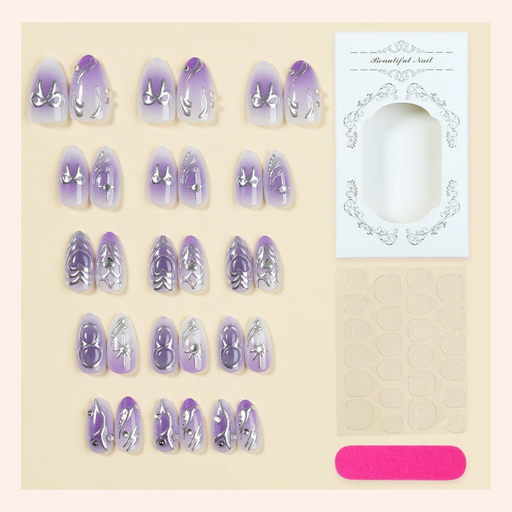 Acrylic nail set with elegant ombre design and delicate embellishments Kalsten