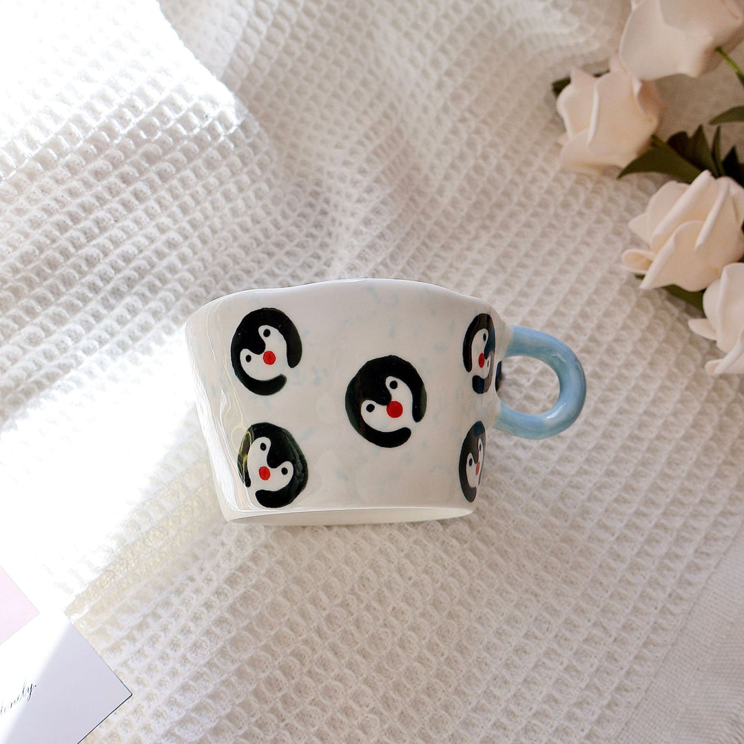 Ceramic mug with hand-painted penguin pattern