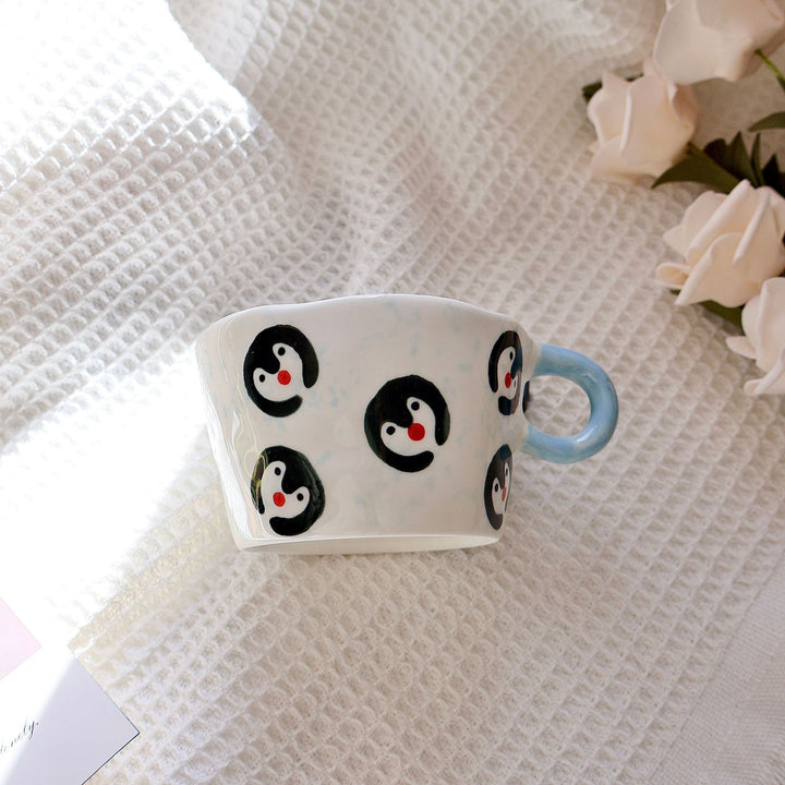 Ceramic mug with hand-painted penguin pattern
