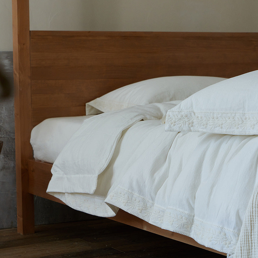 Cotton gauze bedding set with fine tone-on-tone floral embroidery and ruffle