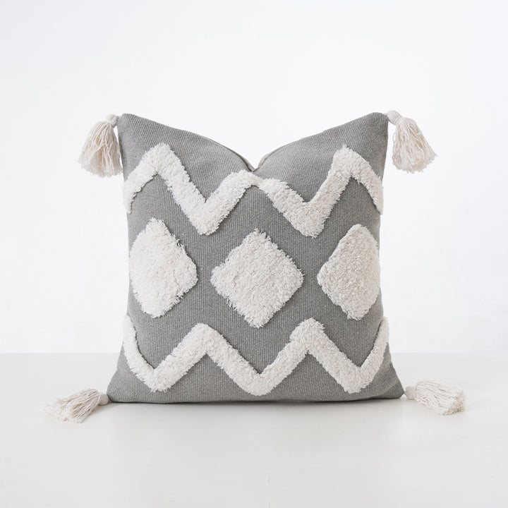 Square decorative cushion with boucle relief, zigzag and diamond pattern as well as tassels