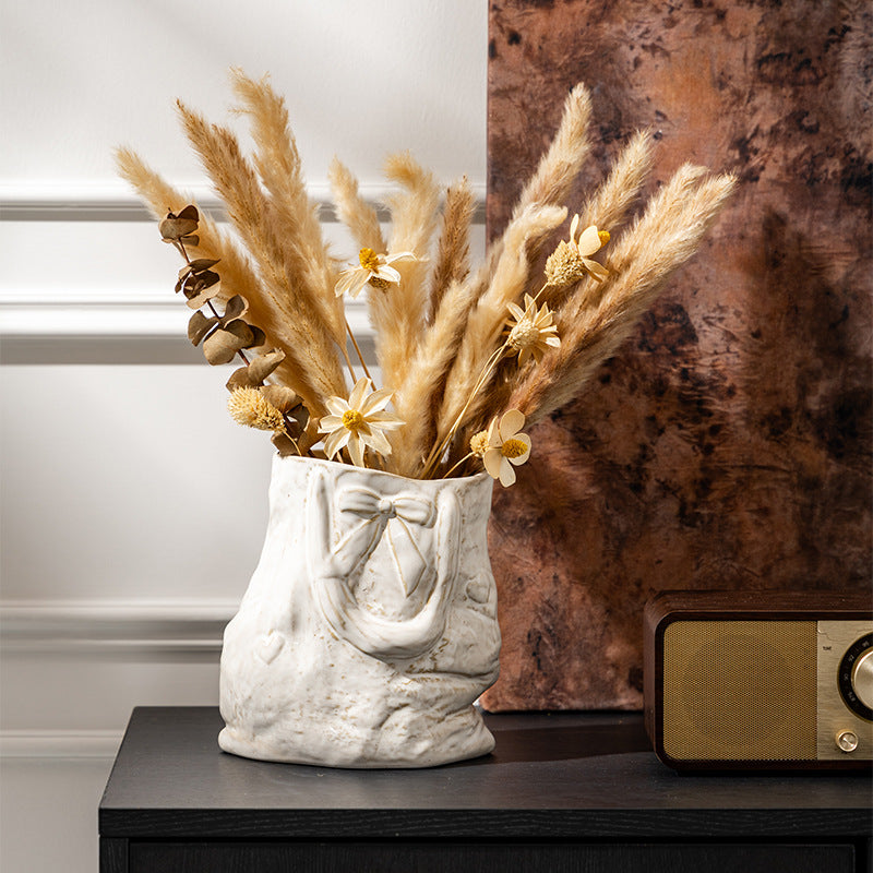 Ceramic hand-engraved bag-shaped decorative vase with bow relief and textured finish