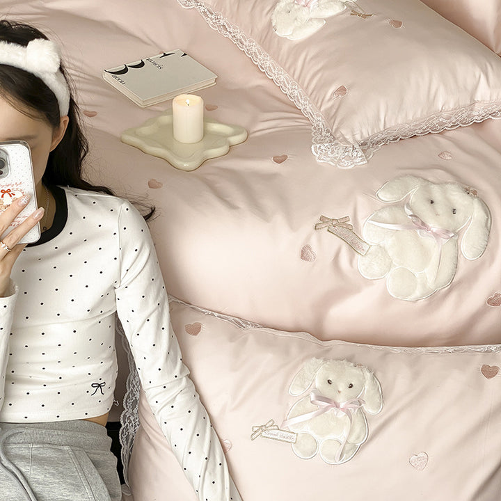 Luxurious satin bedding set with plush bunny appliqué and lace trim