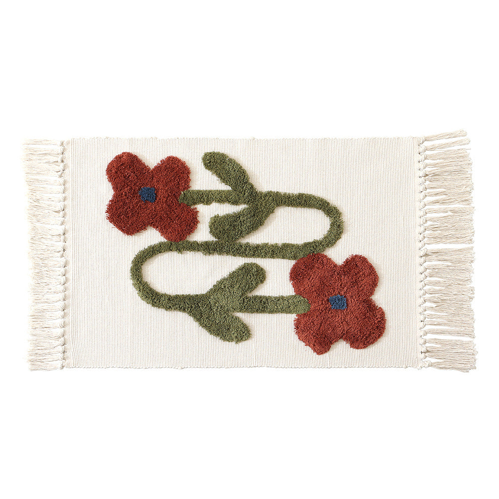 Handwoven cotton bath mat rug with tufted flower appliqué and tassels Kalsten