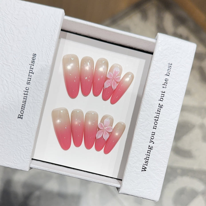 Artificial nails with romantic ombre design and floral accents Kalsten