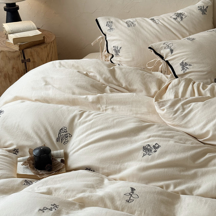 Breathable cotton-linen bedding set with delicate floral embroidery and bow closure
