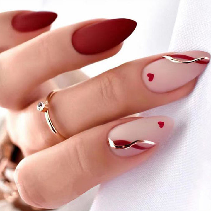 Artful stiletto nails with heart-shaped accents Kalsten