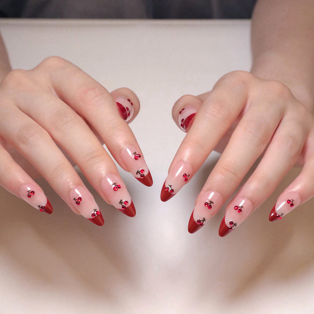 Artful stiletto nails with cherry motifs and glitter accents Kalsten