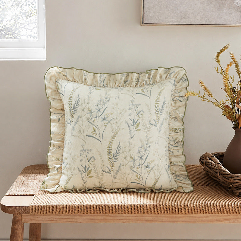 Decorative pillow with ruffles and floral linen cover