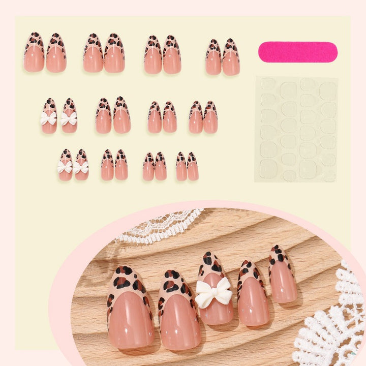 Artificial nail set with elegant leopard design and playful bow accents Kalsten