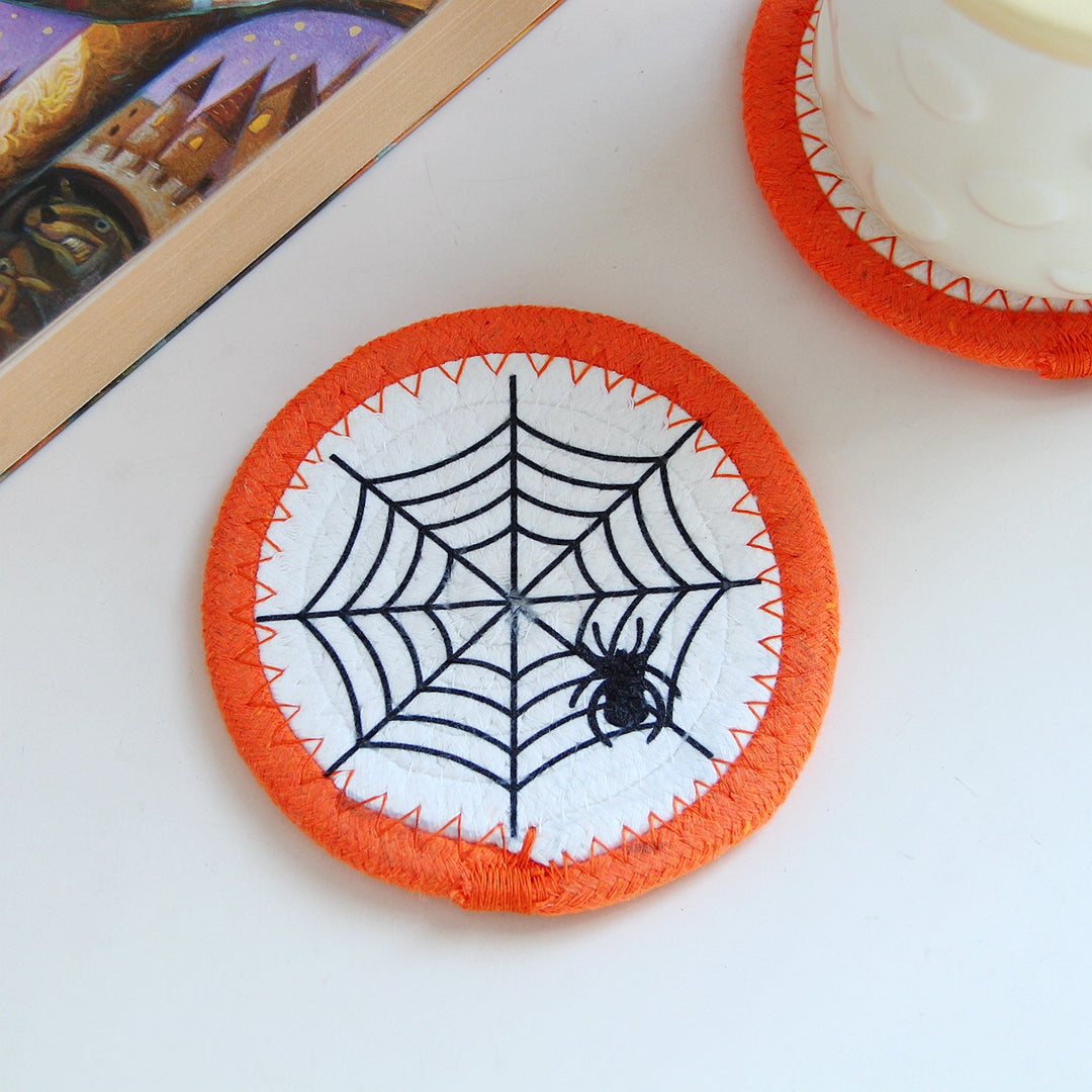Round felt and cotton coasters with embroidered Halloween haunted house motif