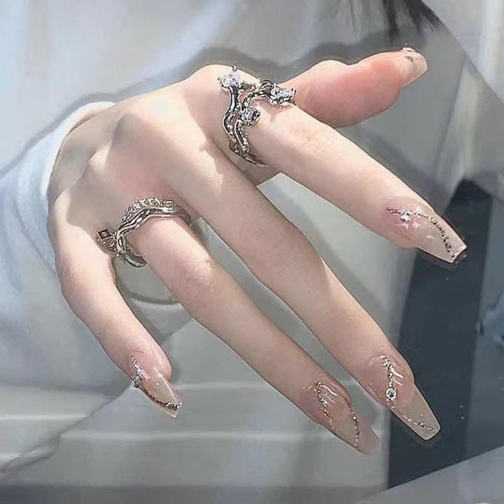 Glamorous artificial nails with delicate flower and glitter effects Kalsten