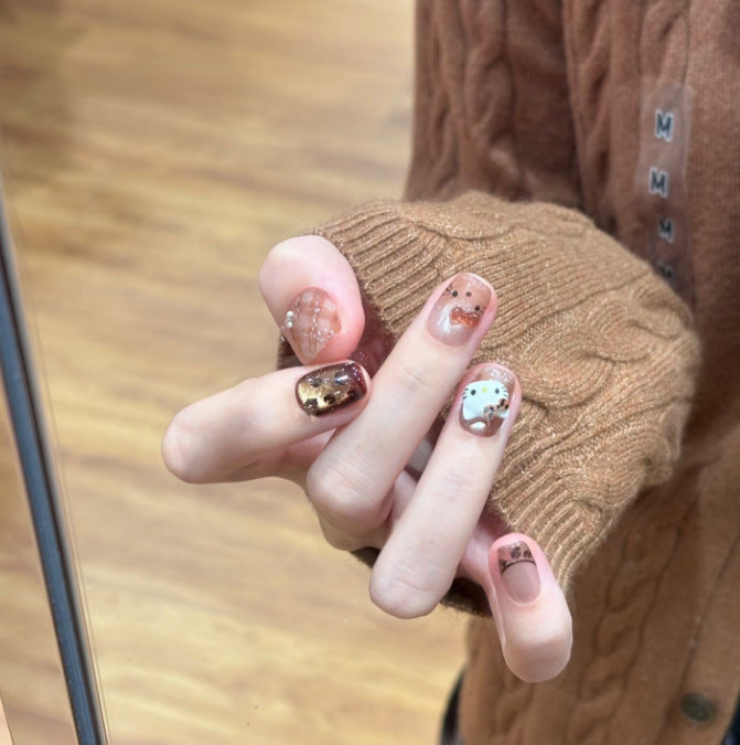 Artificial nail set with festive gift design and elegant glitter accents Kalsten