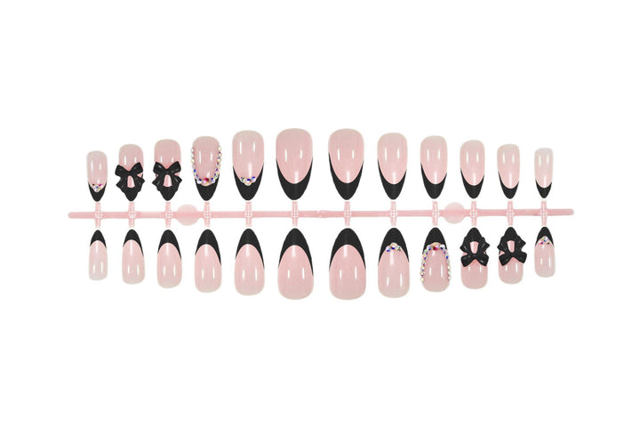 Artificial nail set with glamorous bow design and sparkling accents Kalsten