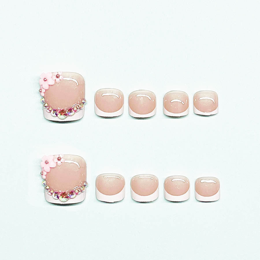 Elegant toenail art with delicate 3D floral decorations Kalsten