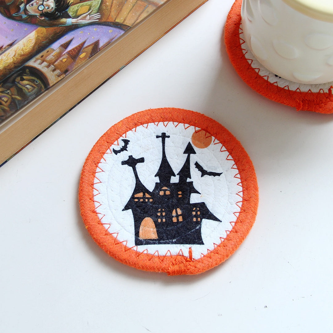 Round felt and cotton coasters with embroidered Halloween haunted house motif