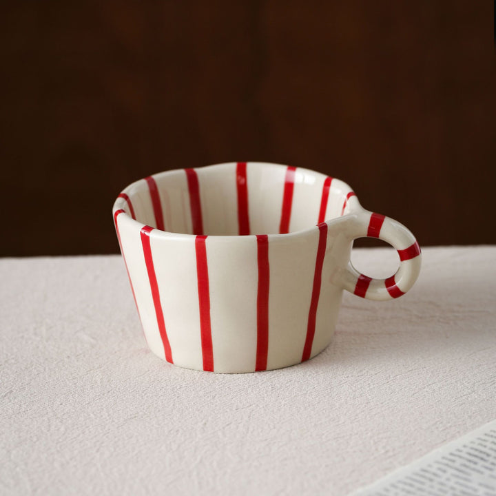 Handmade ceramic mug with ergonomic handle and wavy rim
