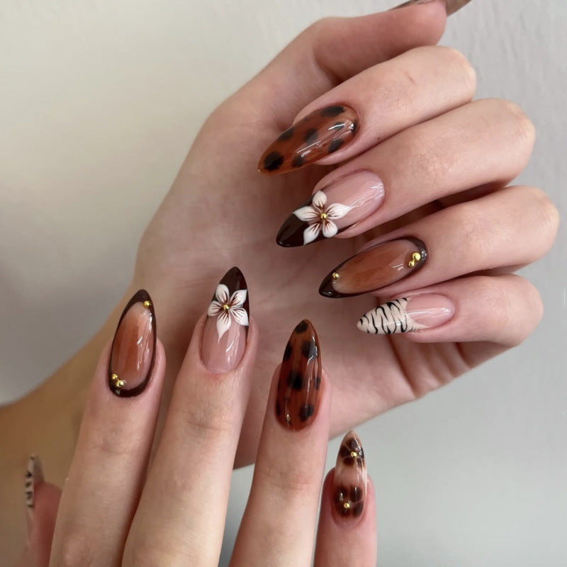 Artistic stiletto nails with elegant floral designs and glitter accents Kalsten