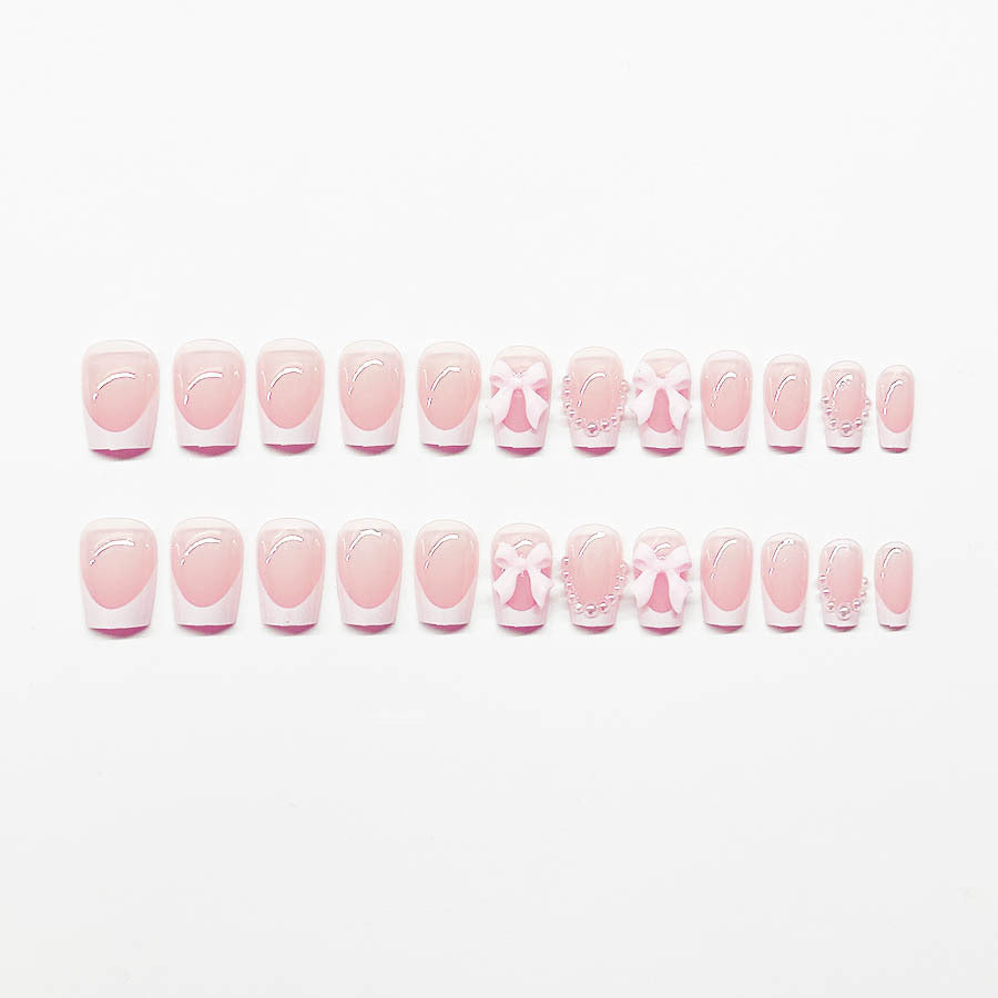 Artificial nails with elegant bows and pearl embellishments Kalsten