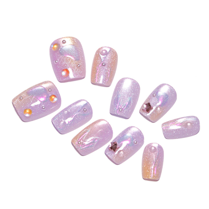 Artificial nail art with sparkling accents and transparent color gradient Kalsten