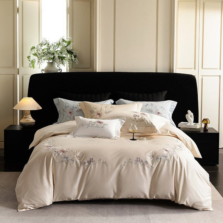 Luxurious embroidered satin bed linen set with floral corner motif and contrast piping