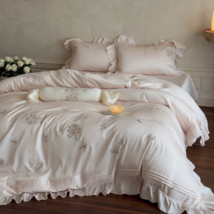 Romantic satin duvet cover set with ruffled trim, rose embroidery, and decorative pillow Kalsten