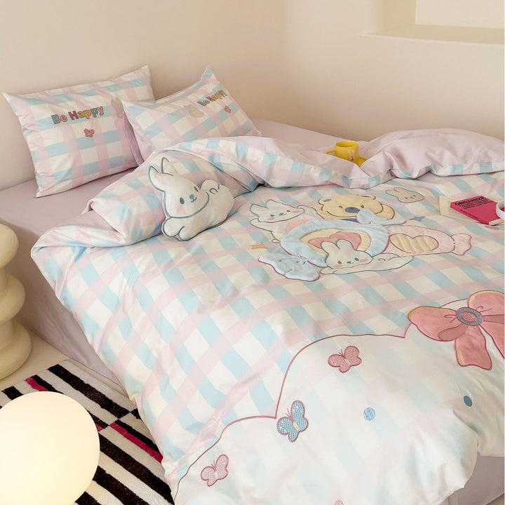 Playful cotton bedding set with embroidered bunny and cherry motif including decorative pillow