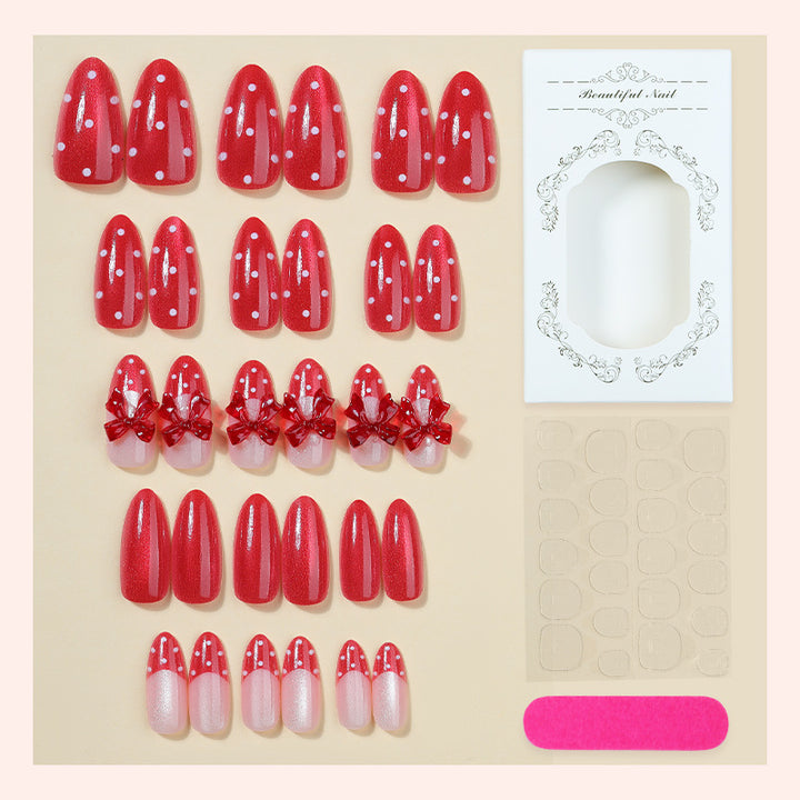Nail set with playful red polka dots and bow accents Kalsten