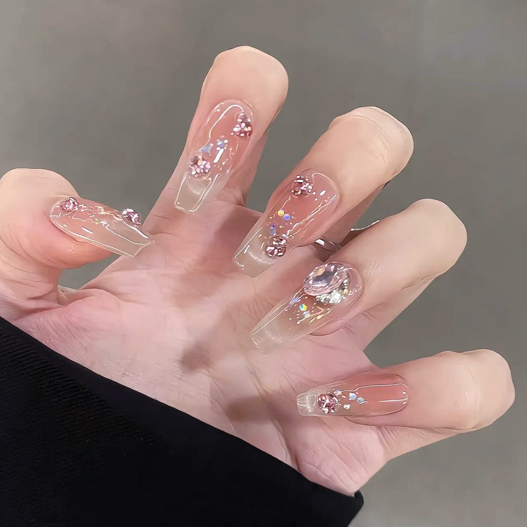 Artificial nail extensions with artistic glitter accents Kalsten