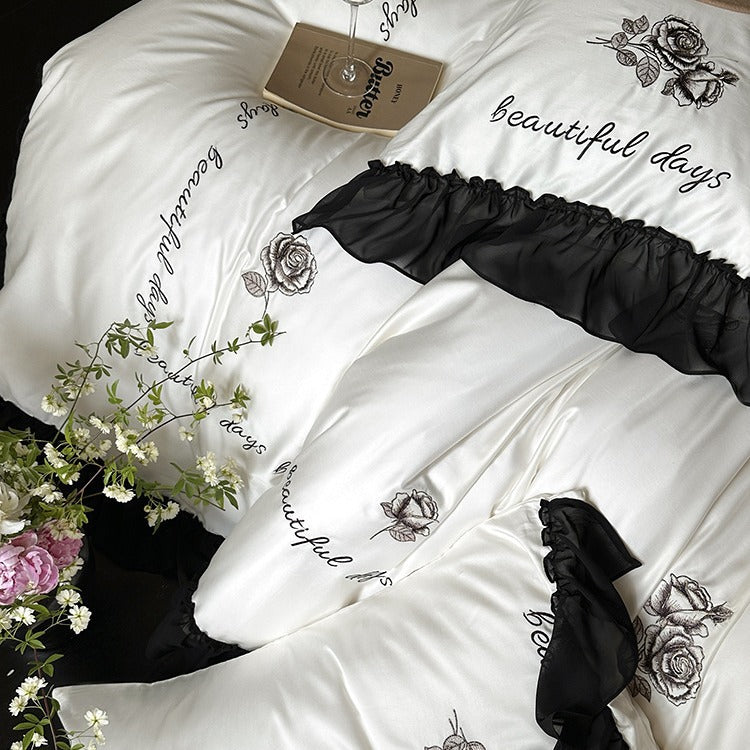 Bedding set made of silky-soft cotton satin with ruffle, delicate rose embroidery, and decorative lettering