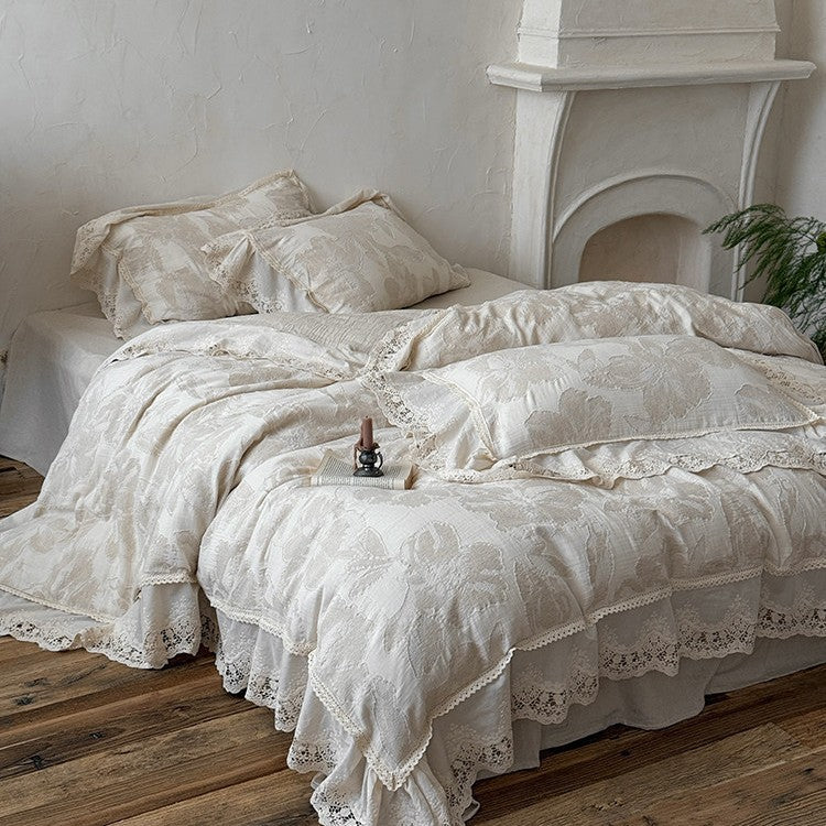 Vintage-inspired cotton-linen bedding set with large floral pattern, ruffle, and lace appliqué