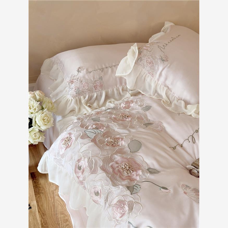Luxurious satin bed linen set with relief-embroidered rose appliqués and ruffles