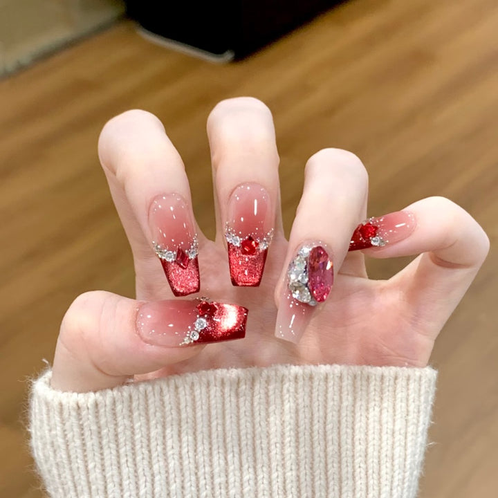 Glamorous artificial nails with sparkling rhinestone applications Kalsten