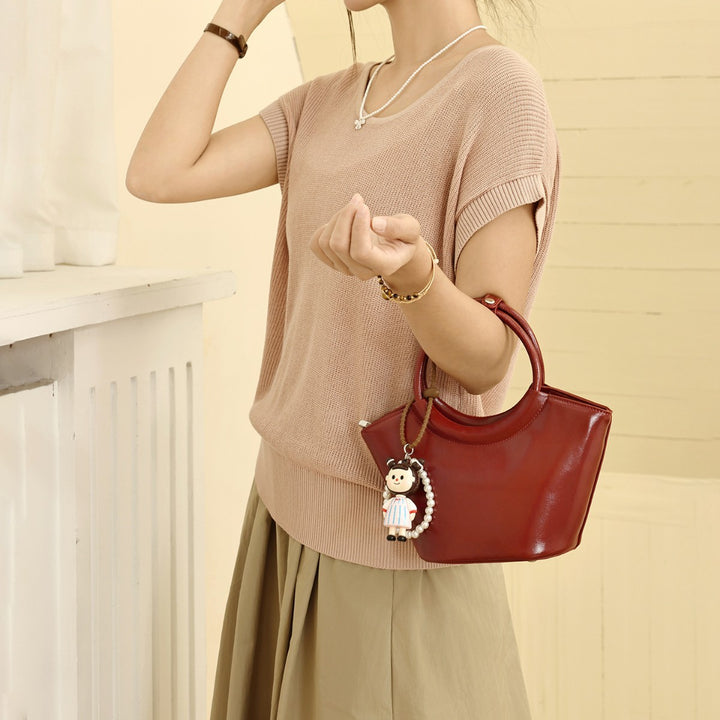 Chic Structured Handbag with Decorative Charm