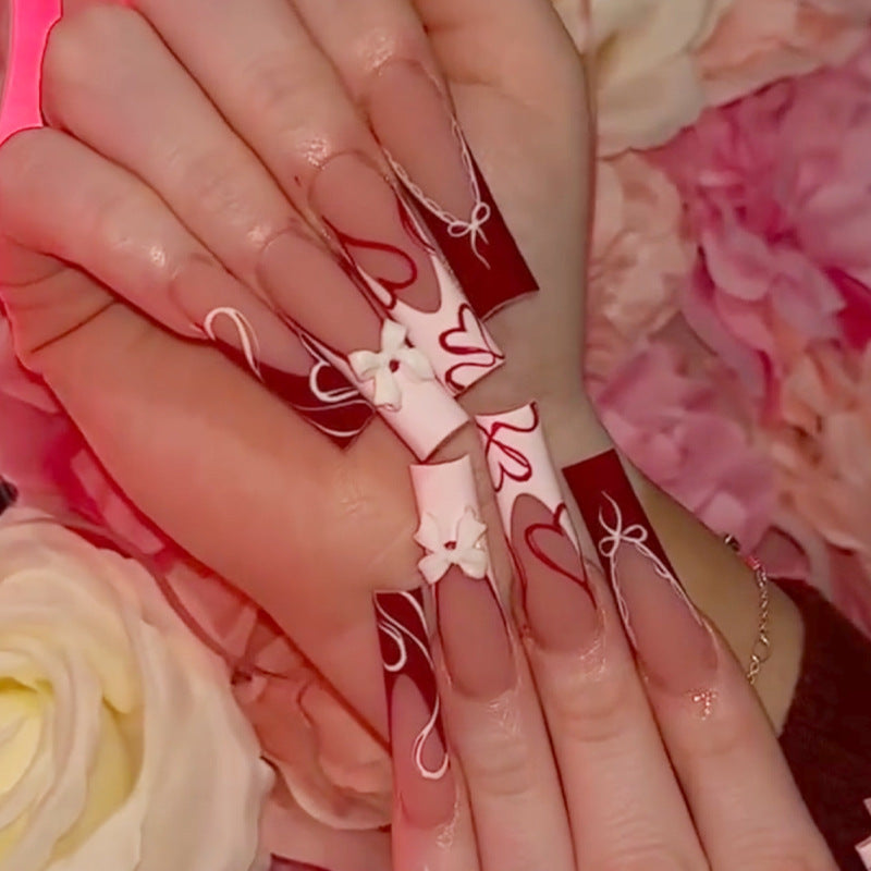 artistic nail set with heart and bow motifs Kalsten
