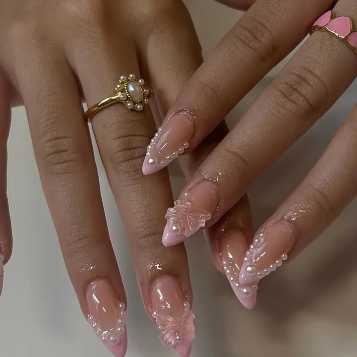 Art nail tips with delicate pearl and butterfly accents Kalsten