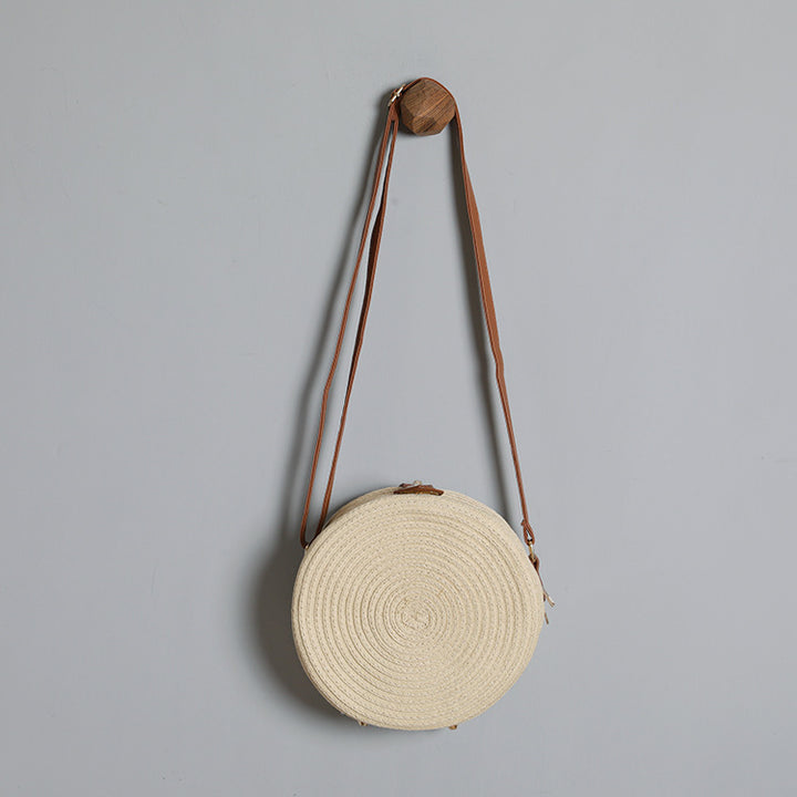 Round shoulder bag made of natural material with stylish accents Kalsten