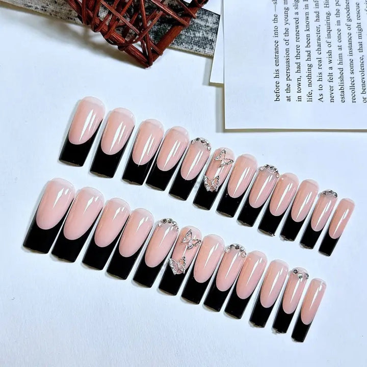 Trendy artificial nails with delicate rhinestone and butterfly accents Kalsten