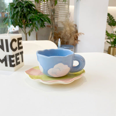 Ceramic coffee set with playful bear reliefs and organic wave saucer