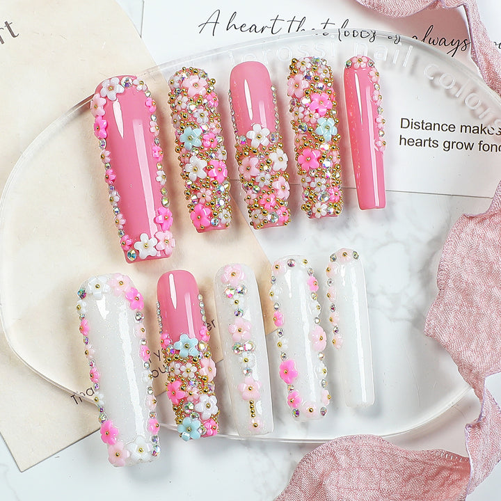 Artificial nail set with floral decorations and glitter accents Kalsten