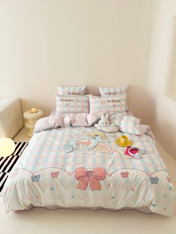 Playful cotton bedding set with embroidered bunny and cherry motif including decorative pillow