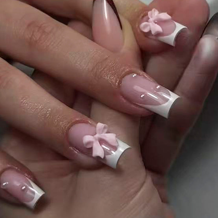 Nail art set with playful ribbon designs and elegant accents Kalsten