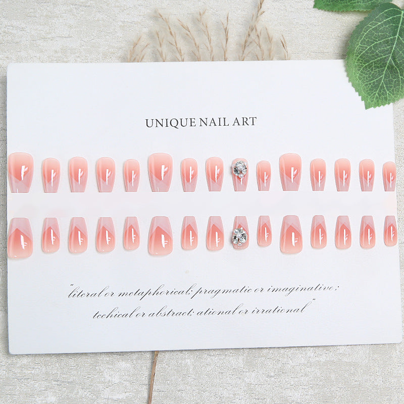 Artificial nail set with filigree tip designs and glamorous rhinestone accents Kalsten